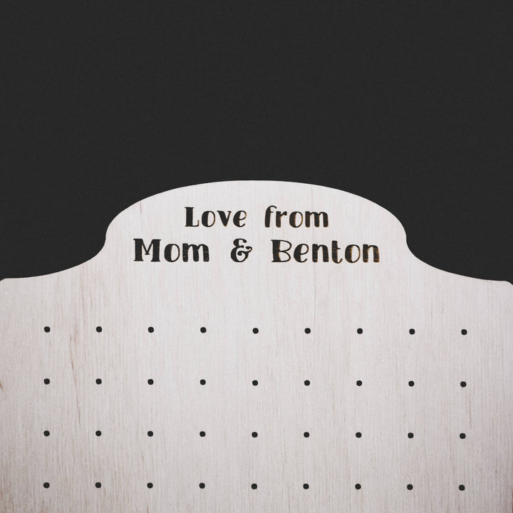 Close-up of engraved earring holder