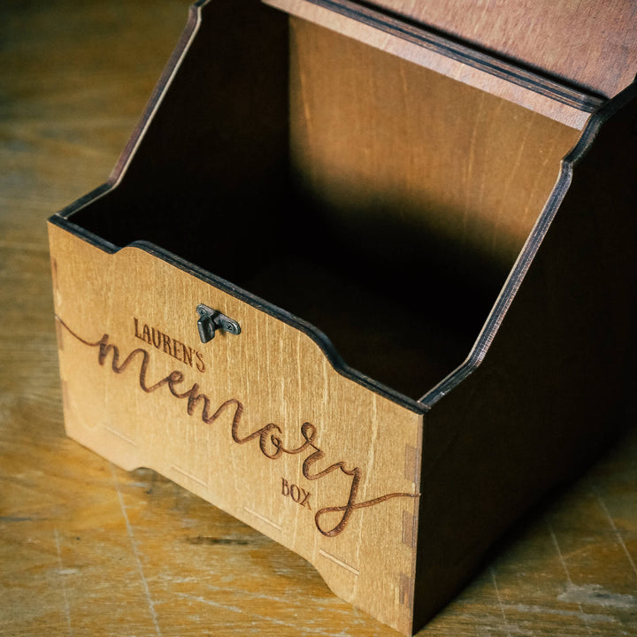 Open wooden memory box showing inside compartments