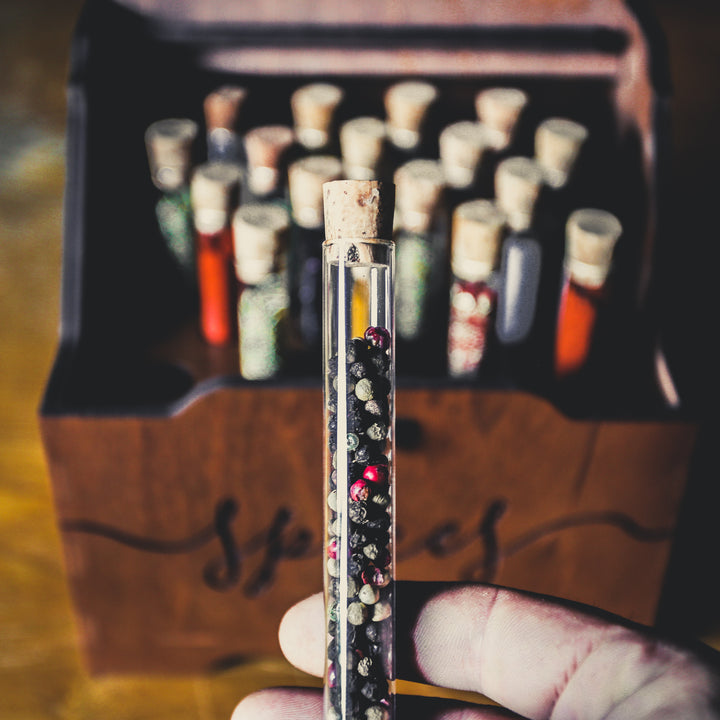 Close-up of glass test tubes with cork plugs in wooden spice box