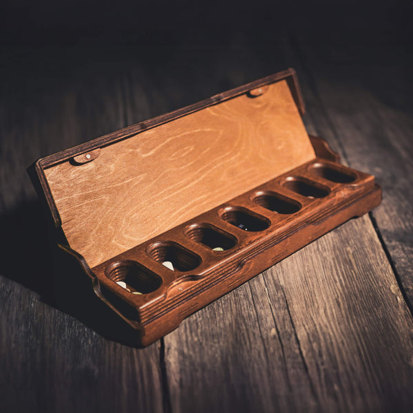 Wooden pill box with open lid and compartments